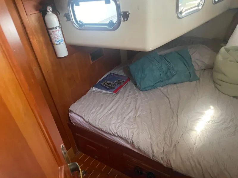 Slide: The Image of Cozy cabin interior of 2001 Tartan 4100 sailboat with bed and portholes. - 37