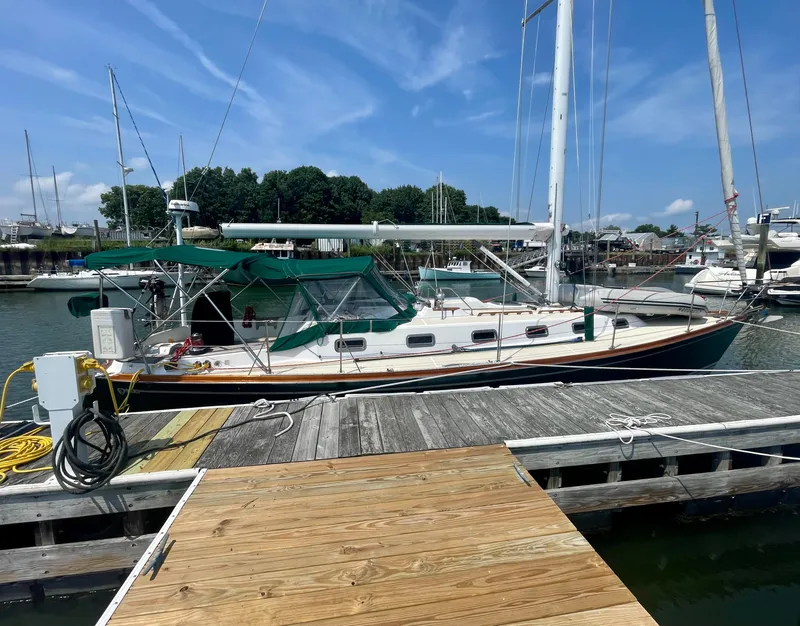 Slide: The Image of 2001 Tartan 4100 sailboat docked at marina under clear blue sky. - 6
