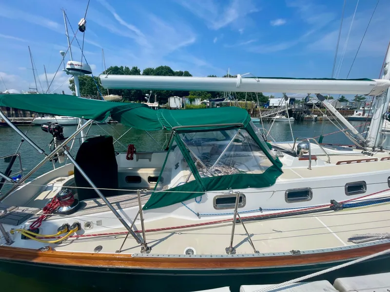 Slide: The Image of Tartan 4100 sailboat, 2001 model, docked with green canopy and clear skies. - 8