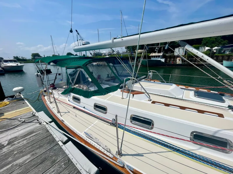 Slide: The Image of Tartan 4100 sailboat, 2001 model, docked in a marina under a clear blue sky. - 9