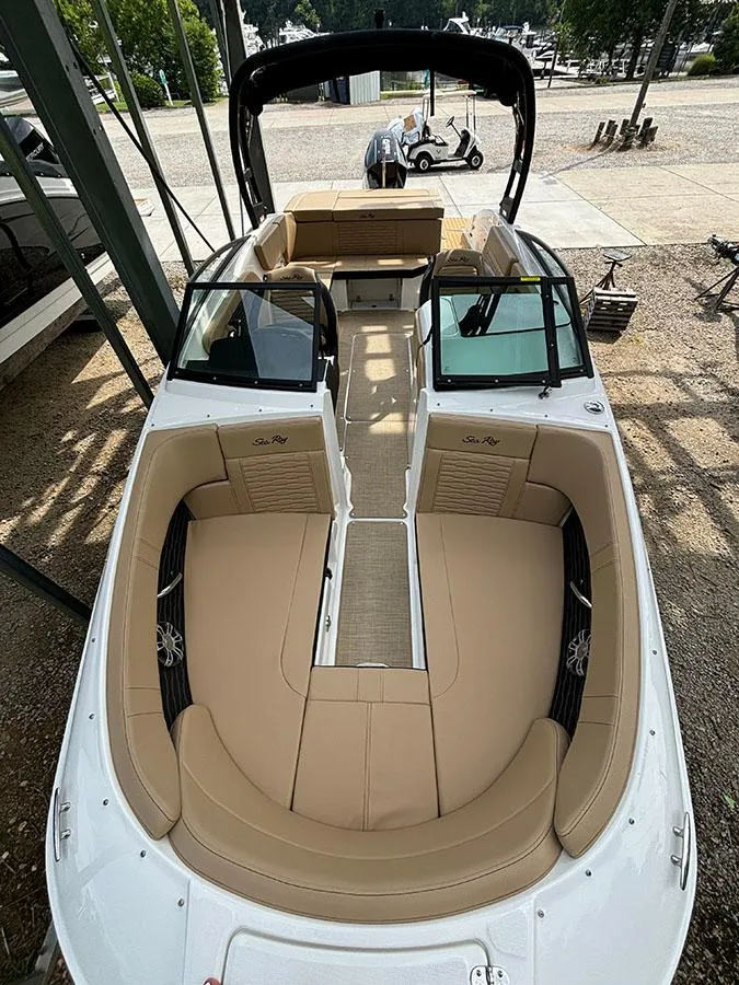 Slide: The Image of 2025 Sea Ray SPX 230 Outboard boat with tan interior and spacious seating. - 10