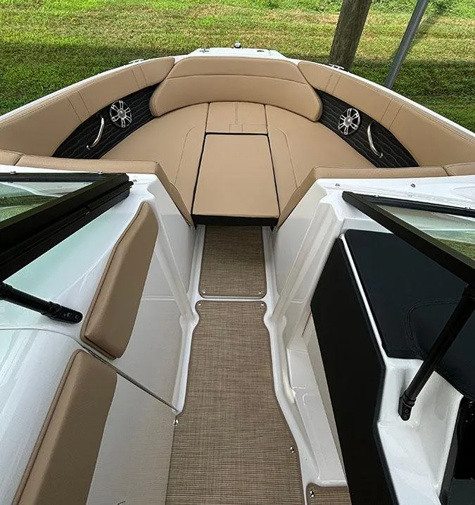 Slide: The Image of 2025 Sea Ray SPX 230 Outboard boat interior with tan seating and modern design. - 11
