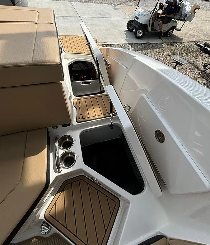 Slide: The Image of 2025 Sea Ray SPX 230 Outboard boat interior with storage compartments and cup holders. - 12