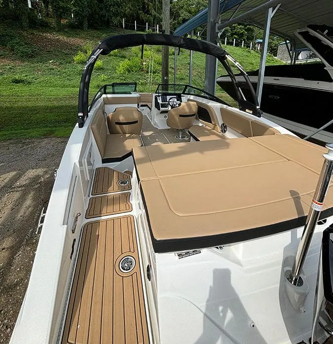 Slide: The Image of 2025 Sea Ray SPX 230 Outboard boat with tan seating and teak flooring. - 14