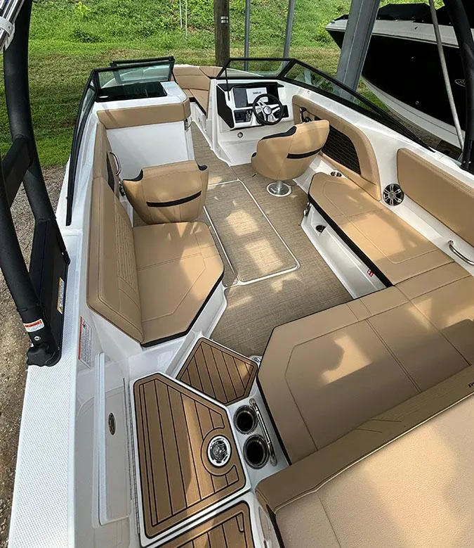 Slide: The Image of 2025 Sea Ray SPX 230 Outboard boat interior with tan seating and modern dashboard. - 15