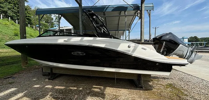 Slide: The Image of 2025 Sea Ray SPX 230 Outboard boat on a dry dock under a canopy. - 2