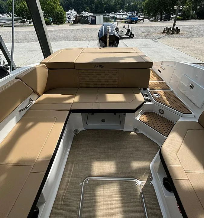 Slide: The Image of 2025 Sea Ray SPX 230 Outboard boat interior with tan seating and spacious layout. - 4