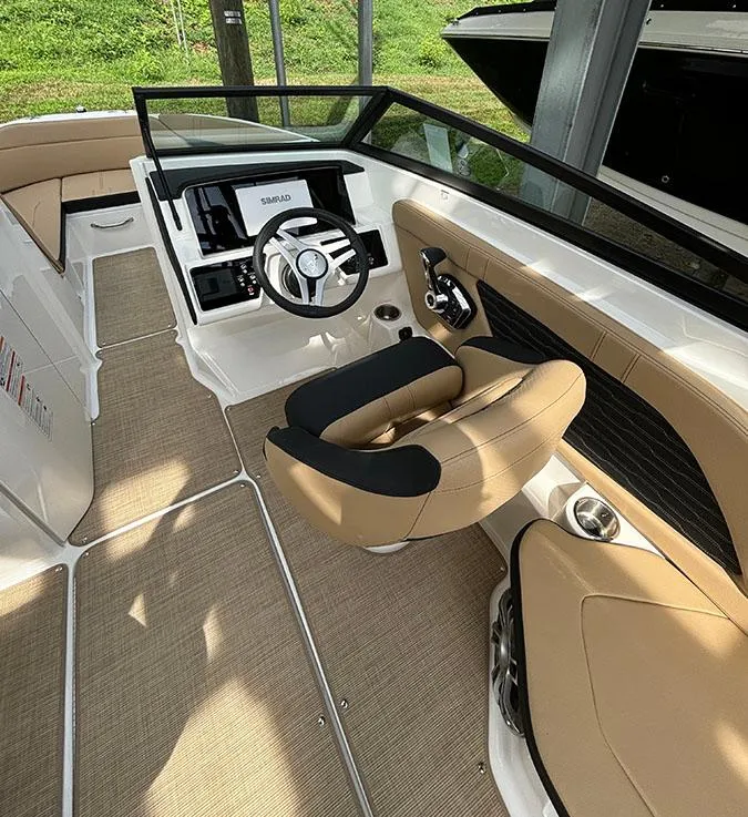 Slide: The Image of 2025 Sea Ray SPX 230 Outboard boat interior with tan seating and modern dashboard. - 5