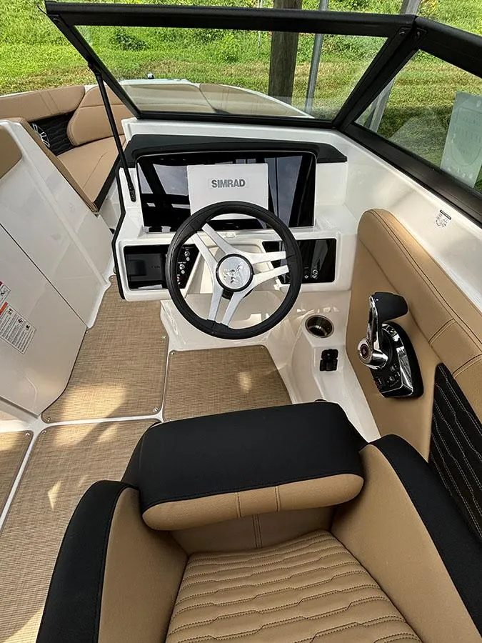 Slide: The Image of Interior of 2025 Sea Ray SPX 230 Outboard boat with modern dashboard and steering wheel. - 8