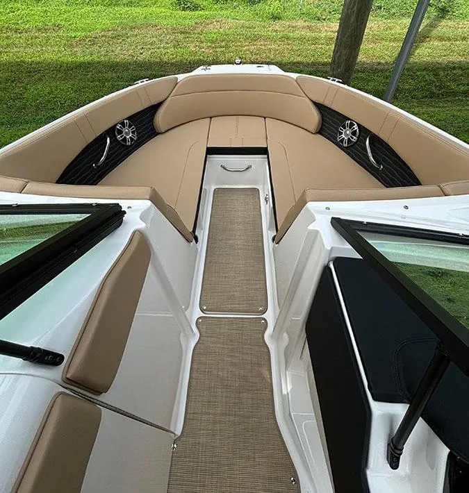 Slide: The Image of 2025 Sea Ray SPX 230 Outboard boat interior with tan seating and modern design. - 9