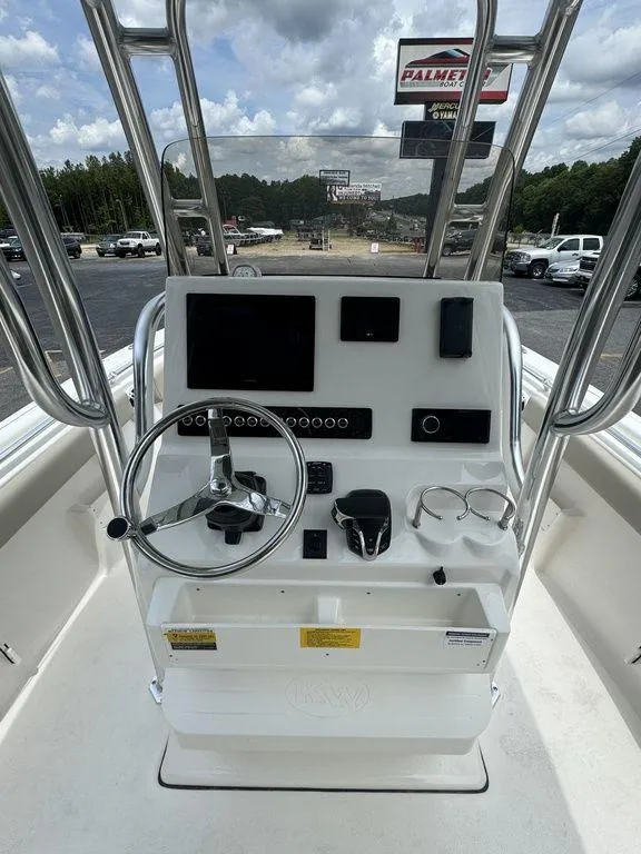 Slide: The Image of 2025 Key West 239FS boat console with steering wheel and navigation controls. - 12