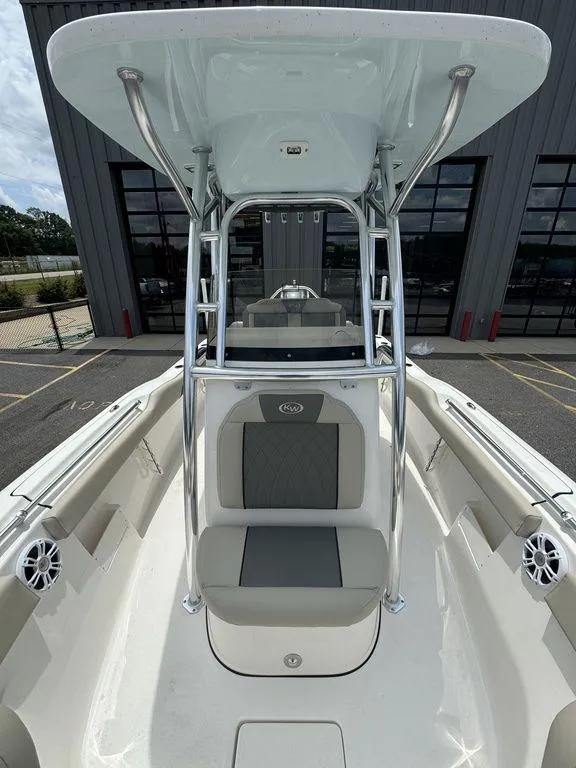 Slide: The Image of 2025 Key West 239FS boat with T-top and seating, docked at marina. - 22