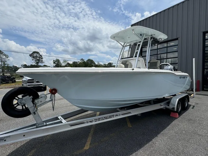 Slide: The Image of 2025 Key West 239FS boat on a trailer outside a building. - 7
