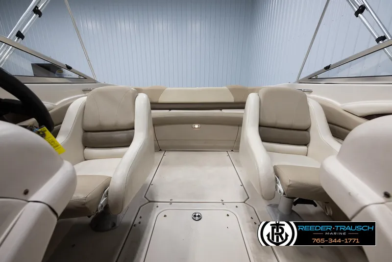 Slide: The Image of Interior of a 2002 Larson LXI 210 boat with beige seating. - 16