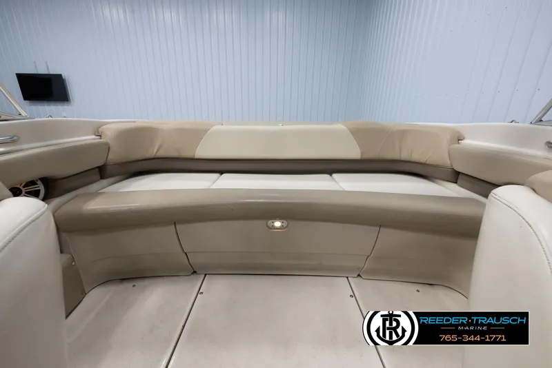 Slide: The Image of 2002 Larson LXI 210 boat interior with beige seating. - 17