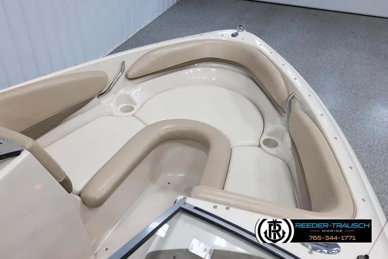 Slide: The Image of Interior seating of a 2002 Larson LXI 210 boat with beige upholstery. - 18