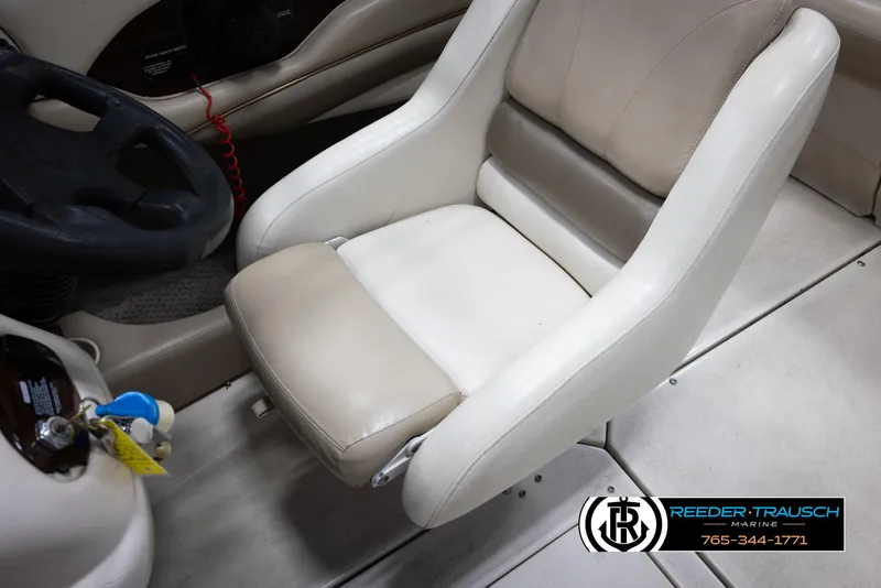 Slide: The Image of 2002 Larson LXI 210 boat captain's chair and steering wheel. - 20