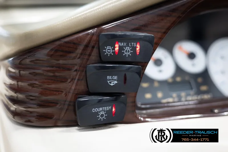 Slide: The Image of Control panel of a 2002 Larson LXI 210 boat with navigation, bilge, and courtesy light switches. - 24