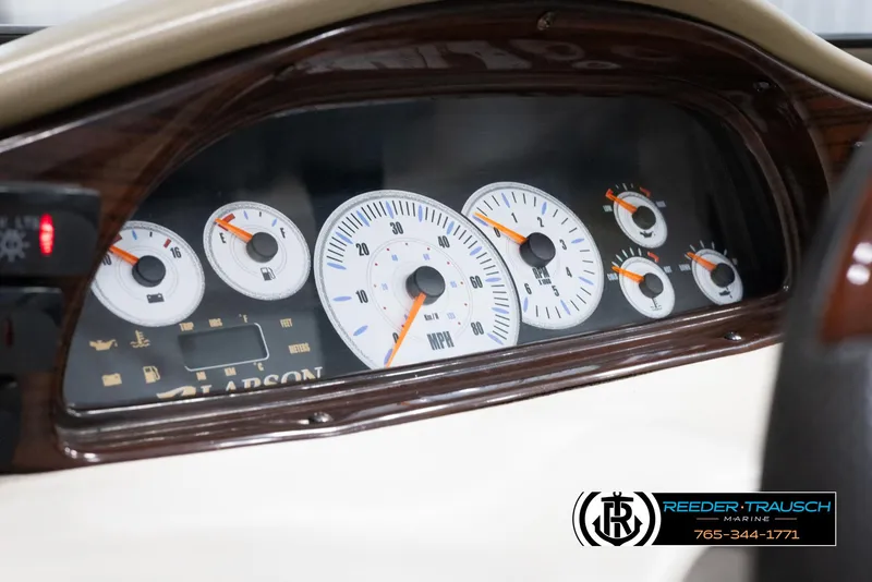 Slide: The Image of 2002 Larson LXI 210 boat dashboard with speedometer and gauges. - 25