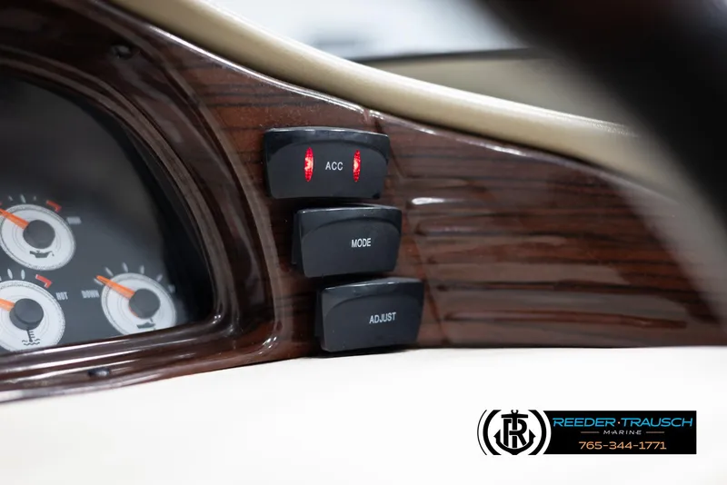 Slide: The Image of Close-up of 2002 Larson LXI 210 boat dashboard with control buttons and gauges. - 26