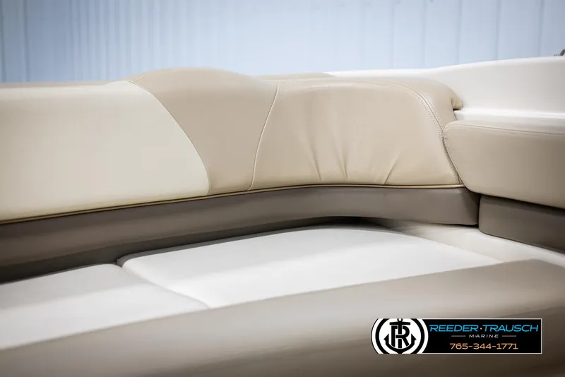 Slide: The Image of 2002 Larson LXI 210 boat interior seating, beige and white upholstery. - 29