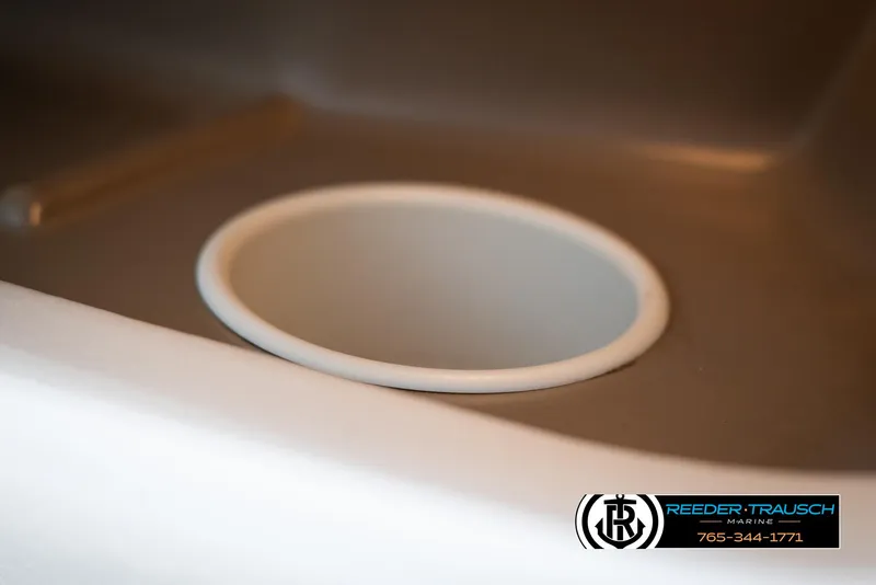 Slide: The Image of Close-up of a cup holder in a 2002 Larson LXI 210 boat. - 32