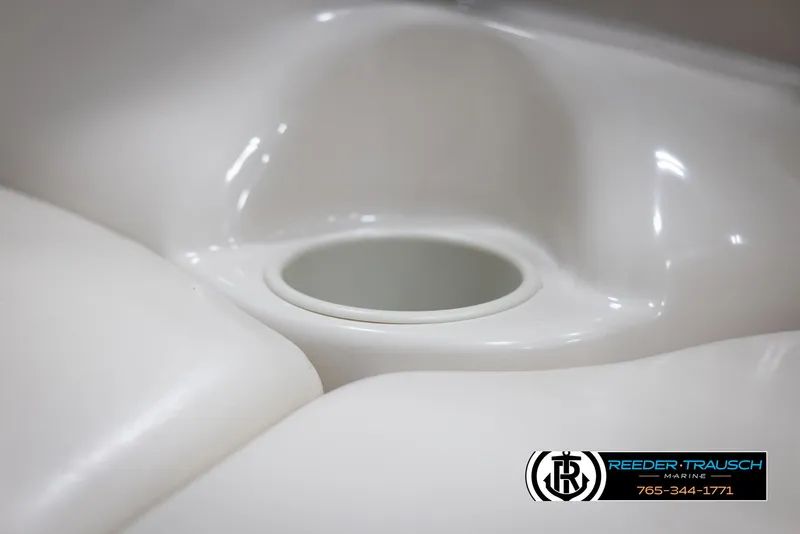 Slide: The Image of Close-up of a 2002 Larson LXI 210 boat's cup holder and seating area. - 33