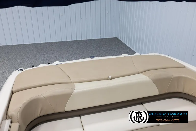 Slide: The Image of 2002 Larson LXI 210 boat interior with beige seating, Reeder-Trausch Marine logo. - 34