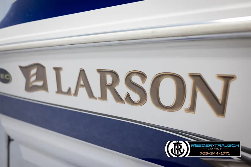 Slide: The Image of 2002 Larson LXI 210 boat side view with logo and Reeder-Trausch Marine contact. - 40