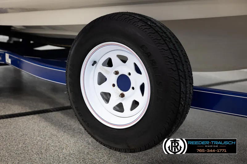 Slide: The Image of 2002 Larson LXI 210 boat trailer wheel with Carlisle tire. - 42