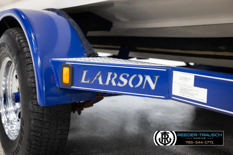 Slide: The Image of 2002 Larson LXI 210 boat trailer with blue fender and logo. - 43
