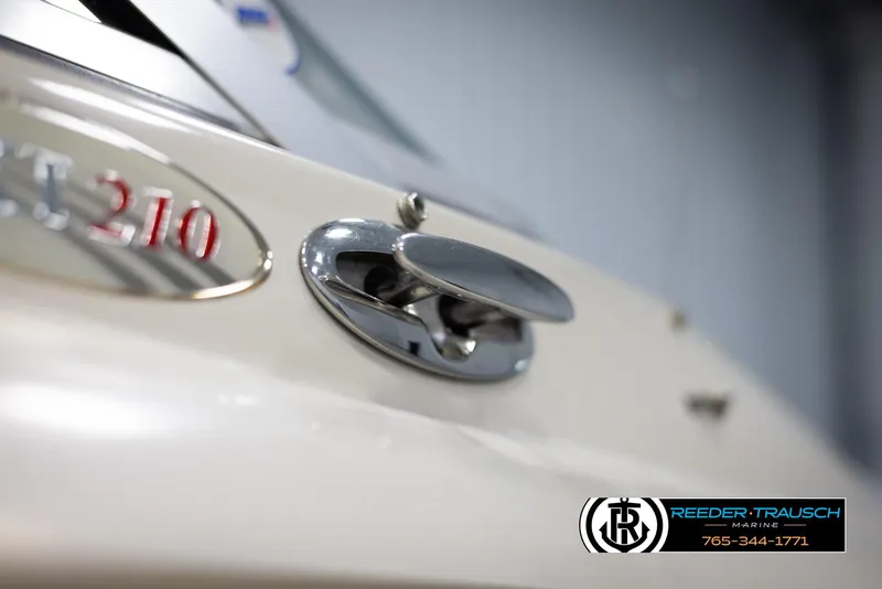 Slide: The Image of Close-up of a 2002 Larson LXI 210 boat with chrome details. - 45