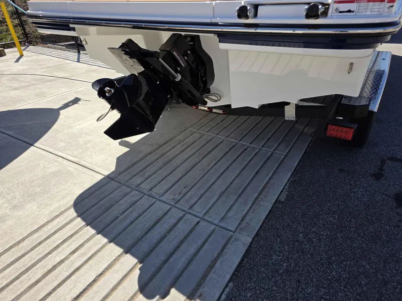 Slide: The Image of 2025 Sea Ray 210SPX boat on trailer, showing propeller and stern drive. - 11