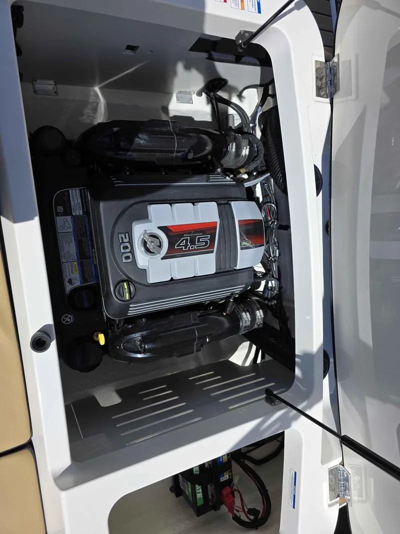 Slide: The Image of Engine compartment of a 2025 Sea Ray 210SPX boat, featuring a 4.5L 200 HP engine. - 12