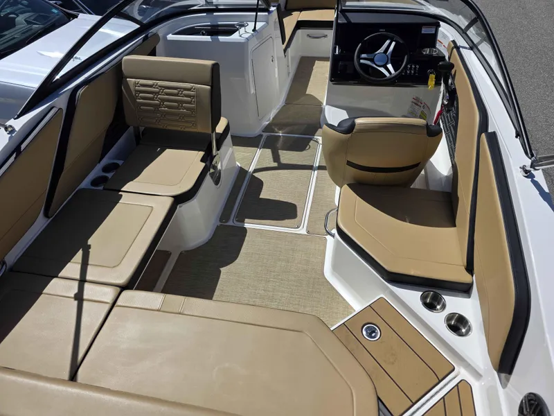 Slide: The Image of Interior of 2025 Sea Ray 210SPX boat with tan seating and modern dashboard. - 6