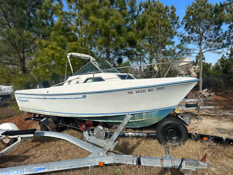 The Image of 1984 Aquasport 222 XF boat on trailer in outdoor setting. - 1