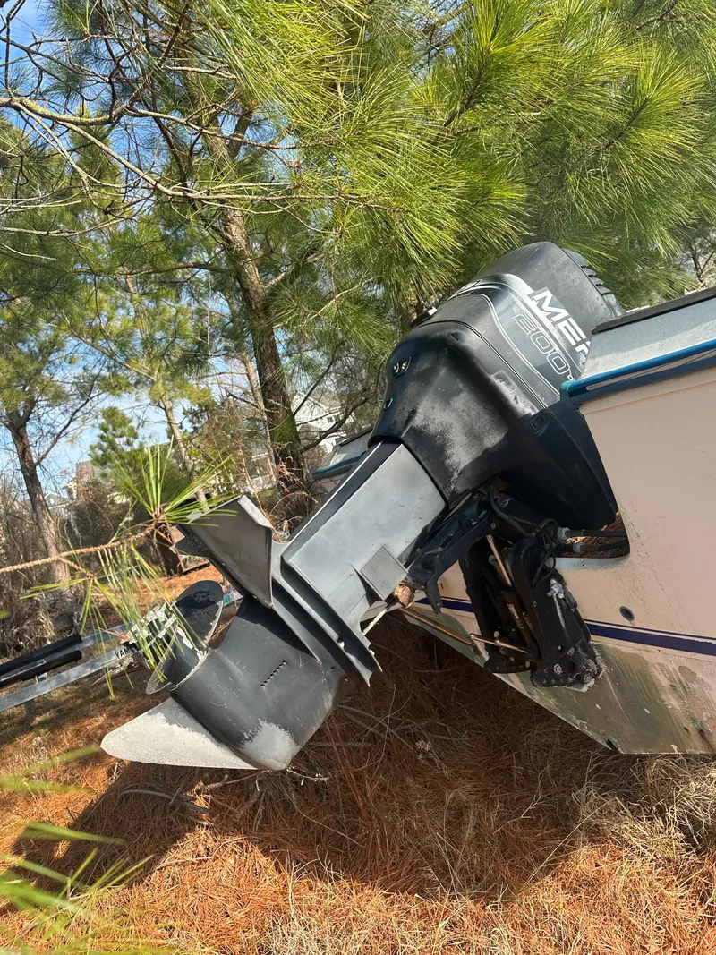 Slide: The Image of 1984 Aquasport 222 XF boat with outboard motor in wooded area. - 3