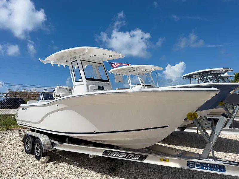 Slide: The Image of 2025 Sea Fox 248 Commander boat on a trailer under a blue sky. - 1
