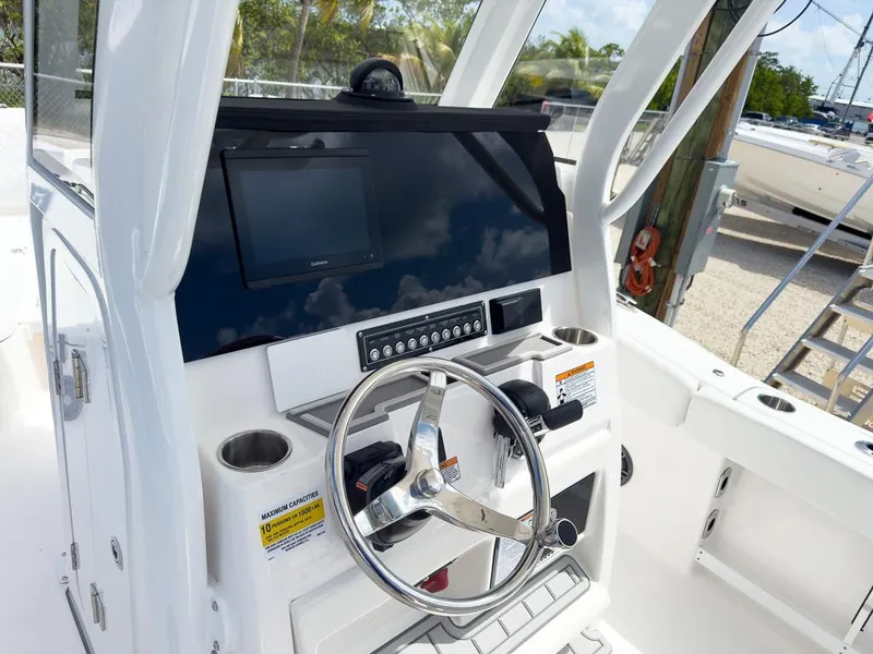 Slide: The Image of 2025 Sea Fox 248 Commander boat console with steering wheel and navigation screen. - 14