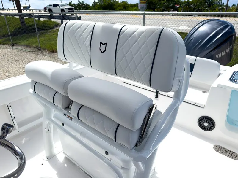 Slide: The Image of 2025 Sea Fox 248 Commander boat with white cushioned seating and Yamaha engine. - 15