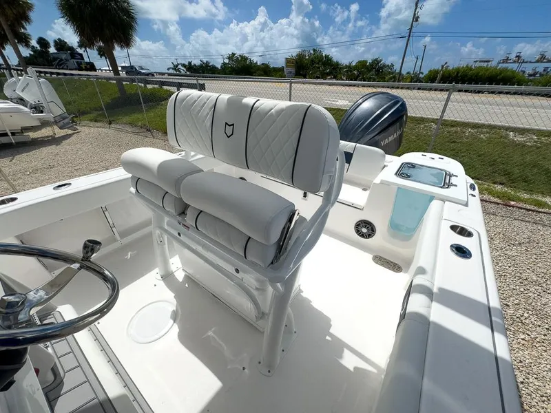 Slide: The Image of 2025 Sea Fox 248 Commander boat interior with white cushioned seating and steering wheel. - 16