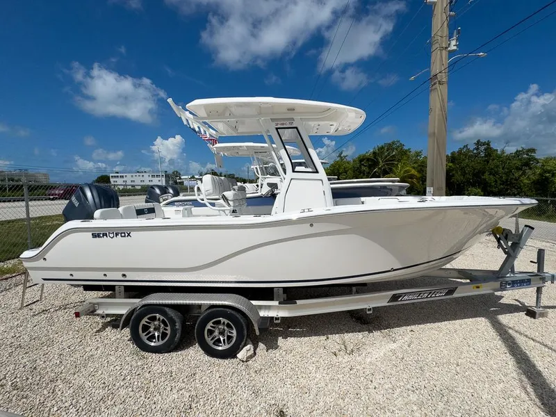 Slide: The Image of 2025 Sea Fox 248 Commander boat on a trailer under a clear blue sky. - 2
