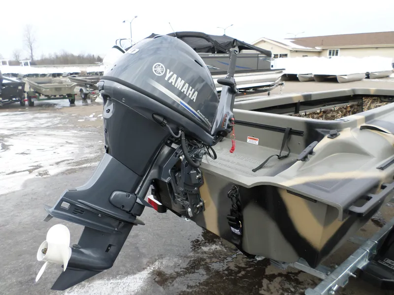 Slide: The Image of 2024 Bankes 14' Dominator boat with Yamaha outboard motor in a parking lot. - 2