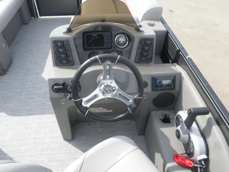 Slide: The Image of 2024 Apex Qwest 820 Lanai LT TRI boat dashboard with steering wheel and controls. - 3