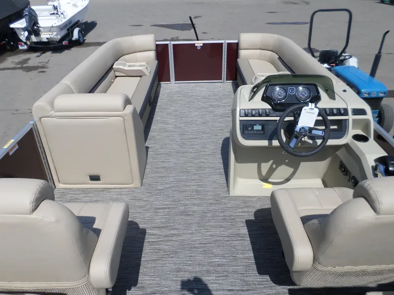 Slide: The Image of 2024 Godfrey Sweetwater 2286SB Tri pontoon boat interior with beige seating and modern dashboard. - 4
