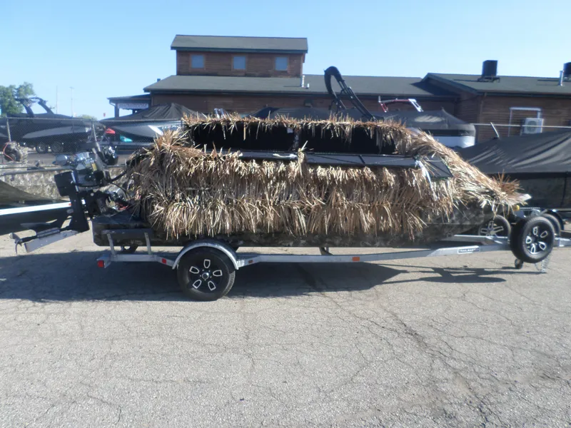 Slide: The Image of 2024 Excel 1860 SWV4 OFP boat with camouflage cover on a trailer. - 1