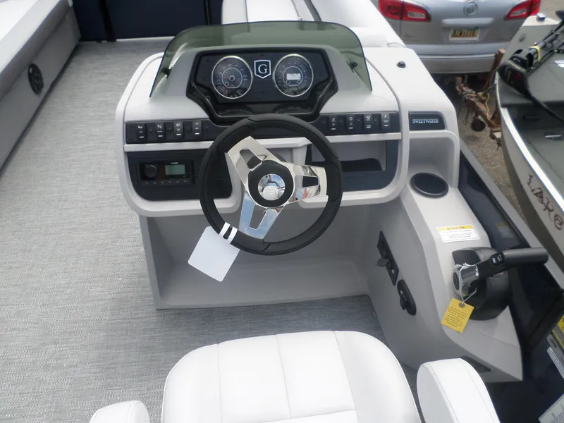 Slide: The Image of 2025 Godfrey Sweetwater 2286 SB Tri boat dashboard and steering wheel. - 5