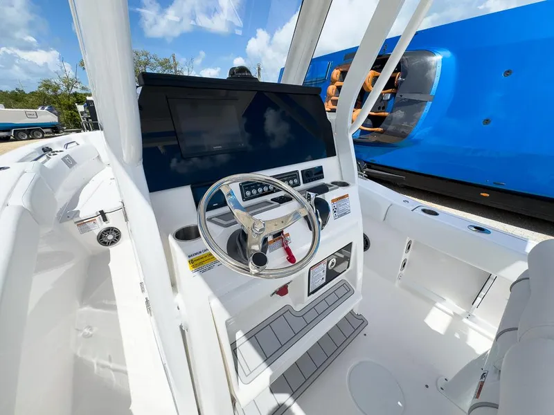 Slide: The Image of 2025 Sea Fox 248 Commander boat helm with modern controls and steering wheel. - 12