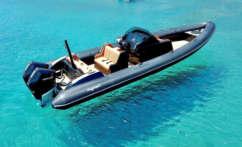 Slide: The Image of Roughneck 1010 boat, 2022 model, floating on clear blue water. - 10