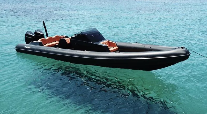 Slide: The Image of Roughneck 1010 boat, 2022 model, floating on clear turquoise water. - 11